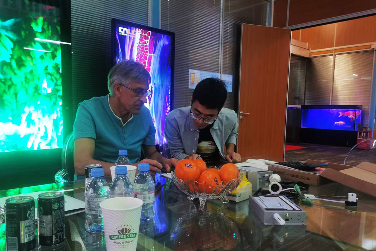 CNLC representatives and customers discussing LED Billboard partnerships.
