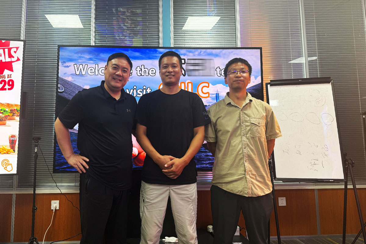Business executives reviewing high-brightness LCD digital signage for urban projects.