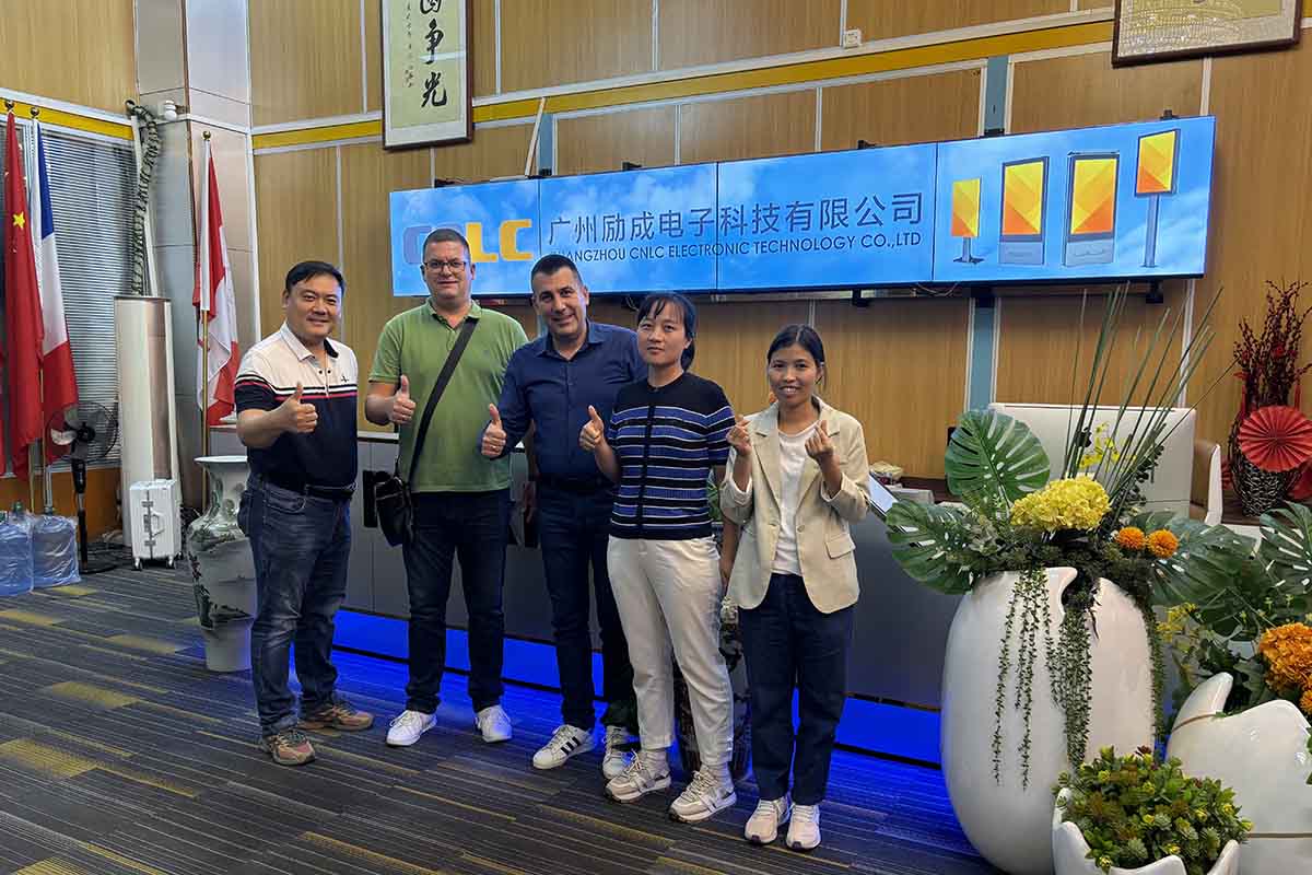 CNLC team and international clients celebrating a successful LED Billboard partnership.