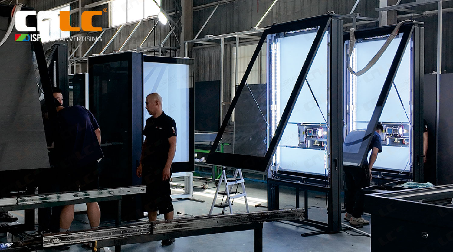 Assembly of bus stop LED totem display at CNLC production facility, showing high-quality manufacturing