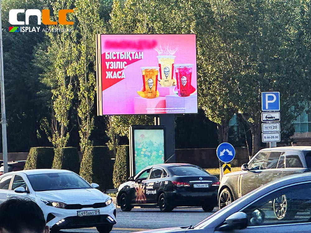 Digital out-of-home (DOOH) LED billboard installed on busy street corner Digital out-of-home (DOOH) LED billboard installed on busy street corner