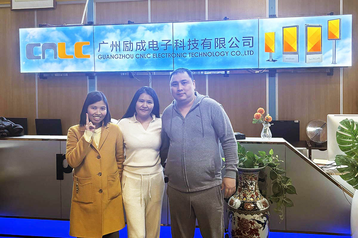 Clients visiting CNLC, a digital signage manufacturer, taking a group photo with the team